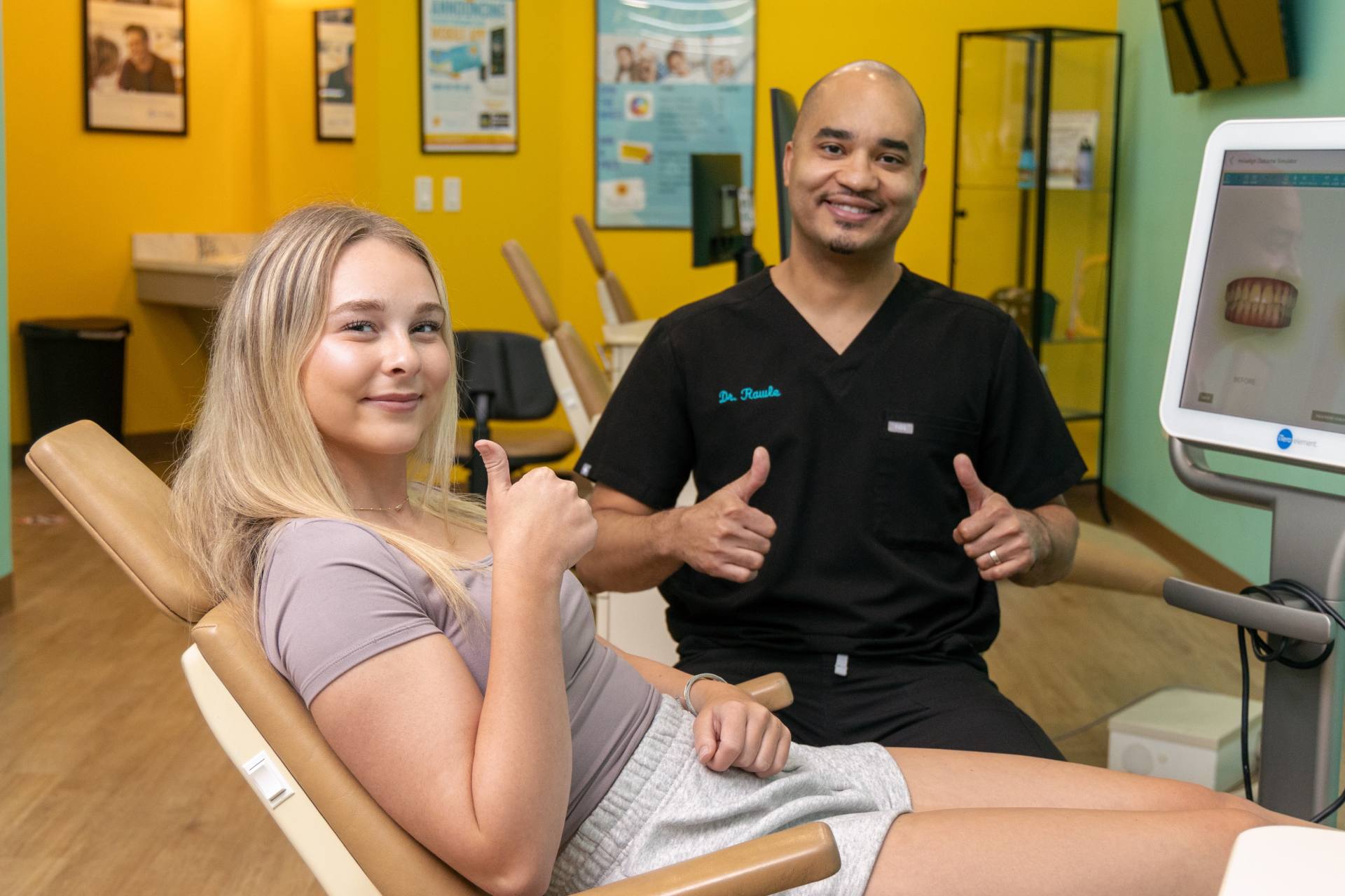 Rawle Orthodontics dentist and patient smiling with thumbs up, showcasing dental aesthetics and laser gum